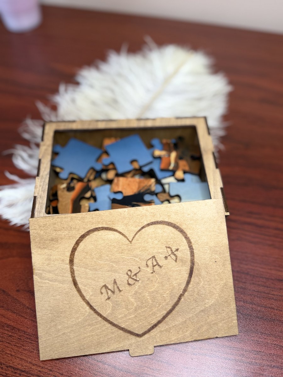 Engraved wooden keepsake box with puzzle pieces inside